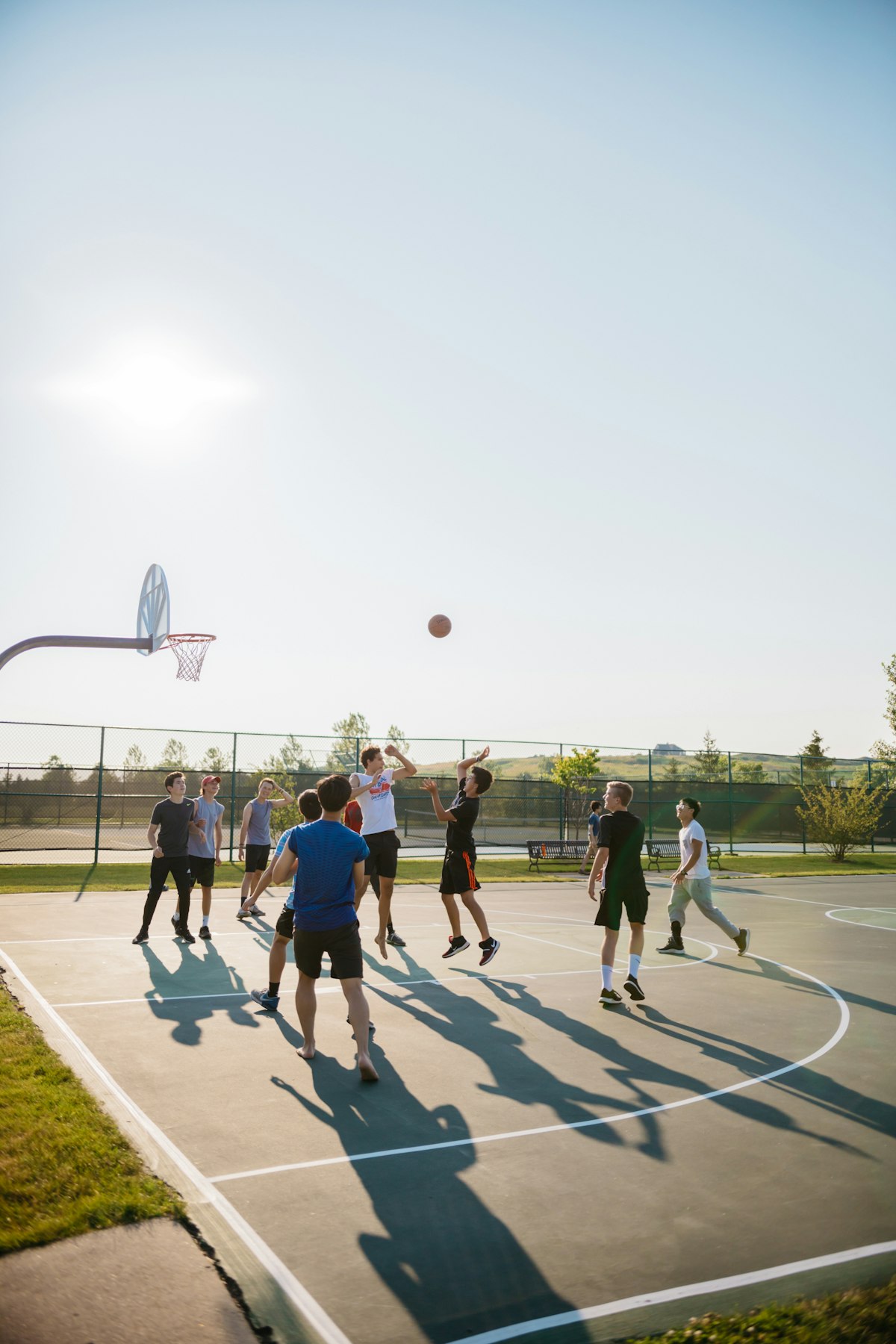 Friends playing basketball on an outdoor court